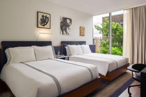 Queen Room with Two Queen Beds and City View room in Thompson Seattle