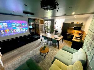 Appartements Capsule Wellness - sauna - balneo - machine de sport privatif - PS5 - 2 chambres : photos des chambres