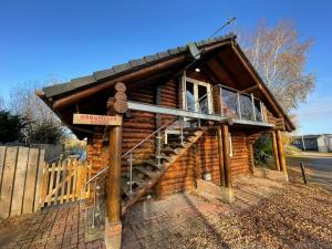 Woodpecker Log Cabin with hot tub, pizza oven bbq entertainment area, lakeside with private fishing peg situated at Tattershall Lakes
