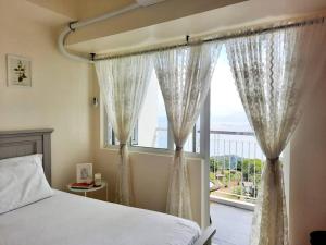1 BR Cozy Farmhouse-Style Condo with Balcony & Taal View at Wind Residences