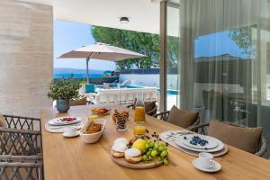 Beachfront Villa Erce with private 40sqm heated pool, a Gym, 7 en-suite bedrooms, a rooftop terrace, 2 living areas