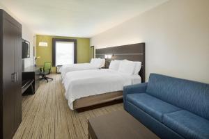 Queen Suite with Two Queen Beds and Sofa Bed room in Holiday Inn Express Hotel & Suites Port Richey an IHG Hotel
