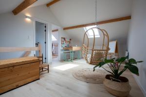 A little white house with a tree by the sea with beach cabin by BLOSS