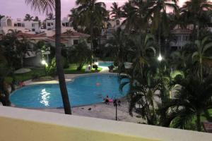 Hermoso apartamento en Manzanillo con alberca y cancha de tenis, Ideal para relajarse y disfrutar de una escapada tranquila en el paraíso tropical