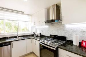 Pristine 4BR Beachfront Getaway with Pool & Rooftop