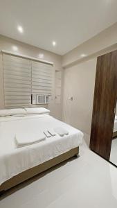 Condo along Tomas Morato w WiFi SmartTV & Karaoke
