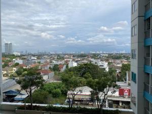 Minimalist room at The Nest Apartment by Popobella Near Puri Indah West Jakarta