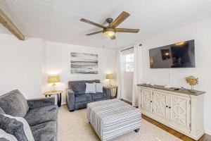 Dog-friendly home with fenced yard, patio, grill, & park across the street