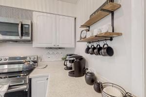 Dog-friendly home with fenced yard, patio, grill, & park across the street