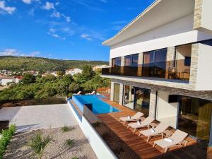 Villa Ramarin III with infinity heated pool, jacuzzi and sauna by the sea in Rogoznica