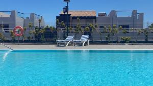 Sunny Luxury Apartment with two great sunny - level terraces, two swimming pools, in a new complex Pueblo Majorero, close to Fuerteventura Golf Club, next to the beach , Atlantico Shopping Mall and casino in Caleta de Fuste