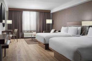 Deluxe Queen Room with Two Queen Beds and Sofa Bed room in Summit Suites