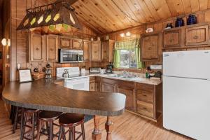Forest Edge Retreat - Cozy, log cabin with a wood burning fireplace! Pool Table, Foosball and Darts!