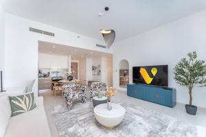 Vogue Vacation Homes, Creek Harbour The Grand Waterfront Living close to Downtown, Burj Khalifa and Dubai Mall, Two Bedroom Apartment with Balcony, Canal and Vibrant Community View, Access toAmenities