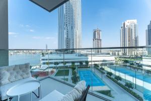 Vogue Vacation Homes, Creek Harbour The Grand Waterfront Living close to Downtown, Burj Khalifa and Dubai Mall, Two Bedroom Apartment with Balcony, Canal and Vibrant Community View, Access toAmenities