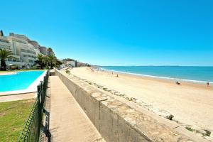 On Beach Deluxe Apartment with Pools and own Garden