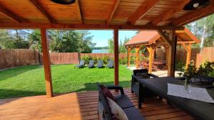 Nad Kalwą - Mazury całoroczny dom do wynajęcia z widokiem na jezioro - pomost - łódka - rower wodny