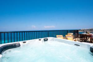 Islet Promenade Seafront Penthouse with breathtaking seaviews and private hot tub on the large terrace by Getawaysmalta