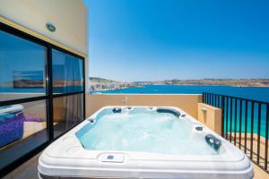 Islet Promenade Seafront Penthouse with breathtaking seaviews and private hot tub on the large terrace by Getawaysmalta