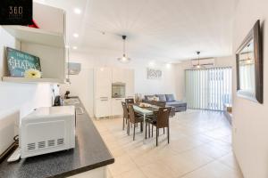 Wonderful, designer 2BR home with large Sofa & TV by 360 Estates
