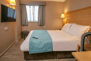 Economy room with double bed and internal window to corridor room in Best Western Heath Court Hotel