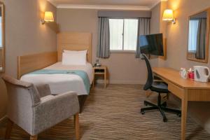 Economy room with single bed and internal window to corridor room in Best Western Heath Court Hotel