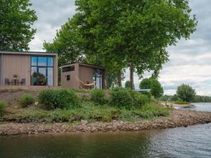 Cozy tiny house on the water, located in a holiday park in the Betuwe