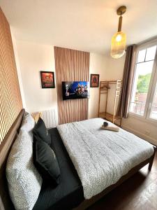 Appartements Le Cocon proche Paris JO 2024 Centre-ville : photos des chambres