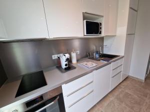 Appartements Au Douni - Appartement avec parking couvert et bureau equipe : photos des chambres