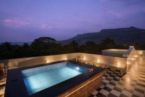 SaffronStays Peshwaai - 5BR Karjat villa with lawn pool & terrace plunge, mezzanine family rooms, near Songiri & Kondhana