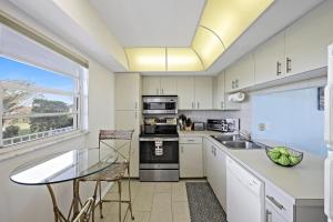 Coastal style condo with pool, spa and steps to beach