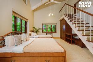 Sea Breeze by StayVista - Beachside bliss with a splash of creativity with Pool, gazebo, lush lawn, and an artistically inspired house