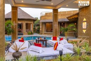 StayVistas Majestic Mud House - Rajasthani Architecture with Modern Amenities, Outdoor Pool, Adventure Activities, and Spa