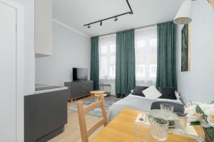 Stylish Grey Apartments with a City View in Poznań by Renters