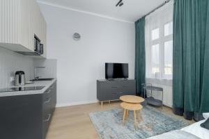 Stylish Grey Apartments with a City View in Poznań by Renters