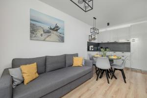 Exclusive and Modern Grey Apartment with Furnished Balcony in Kołobrzeg by Noclegi Renters