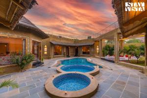 StayVistas Majestic Mud House - Rajasthani Architecture with Modern Amenities, Outdoor Pool, Adventure Activities, and Spa
