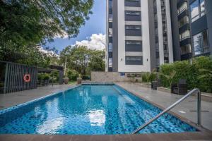 2BR Riverside luxury apartment with balcony & pool views