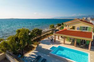 Beach front villa with heated pool, jacuzzi, fantastic view, the sound of the waves - by Traveler tourist agency Krk ID 2404