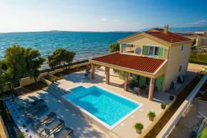 Beach front villa with heated pool, jacuzzi, fantastic view, the sound of the waves - by Traveler tourist agency Krk ID 2404