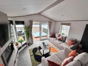 Award winning Serenity Lodge with outstanding lakeside views from the hot tub , at Tallington Lakes Leisure Park, Stamford - Tallington