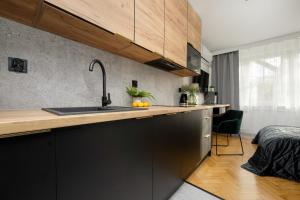 Modern Black & Wooden Apartment Warsaw Near The Airport by Renters