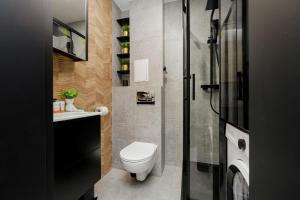 Modern Black & Wooden Apartment Warsaw Near The Airport by Renters