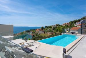 NEW! Three-bedroom Villa Sunshine with a heated pool, media room, and views of the sea