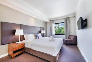 Towering Palms, A Seaside Balcony with Resort Pool