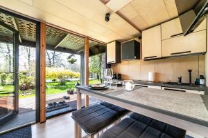 A tiny house with a garden and a hot tube