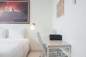 Minimalist Studio Room with City View at West Vista Apartment By Travelio