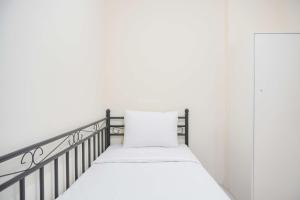 Homey and Comfortable 2BR Tifolia Apartment By Travelio