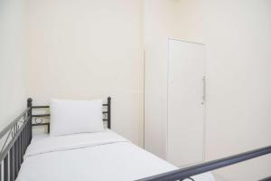 Homey and Comfortable 2BR Tifolia Apartment By Travelio