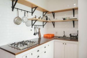 Nice and Homey 1BR at Citralake Suites Apartment By Travelio